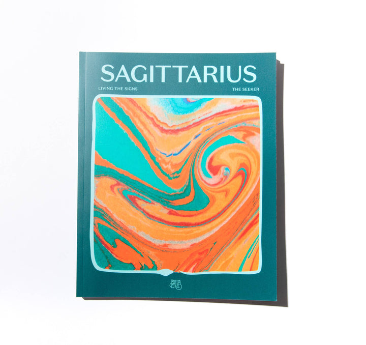 Book titled 'Sagittarius' with a colorful swirl design on a white background Mood by DMJ in Lafayette, Louisiana