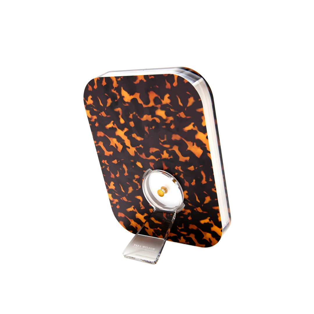 Tortoise acrylic POP Frame with thick clear body and twist-out kickstand.
