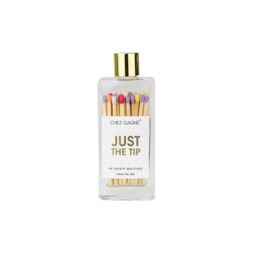 Glass bottle safety matches with colorful tips and gold lid labeled Just The Tip displayed for candle lighting and home décor use