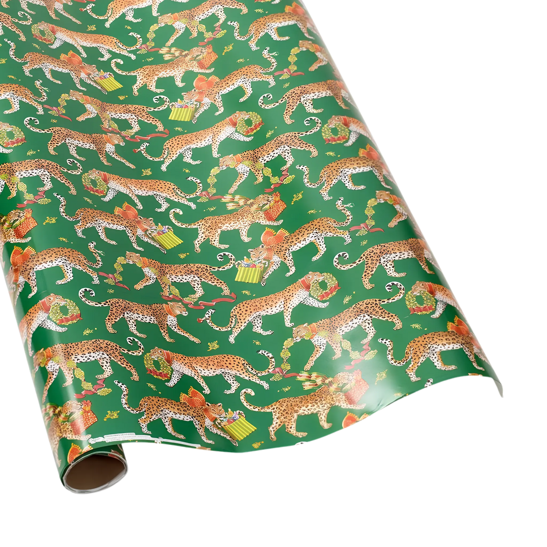 Christmas wrapping paper roll with leopards carrying gold ornaments, gifts, and wreaths on a green background
