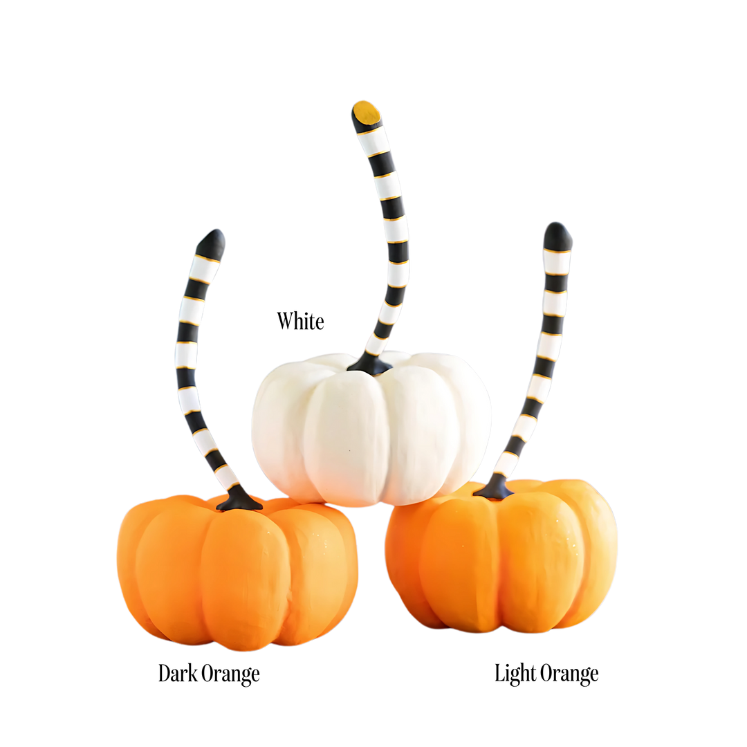 Three pumpkins with striped stems in white, dark orange, and light orange Mood Holiday 2025