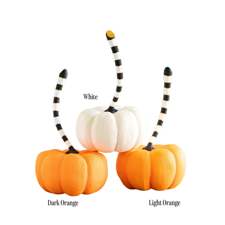 Three pumpkins with striped stems in white, dark orange, and light orange Mood Holiday 2025