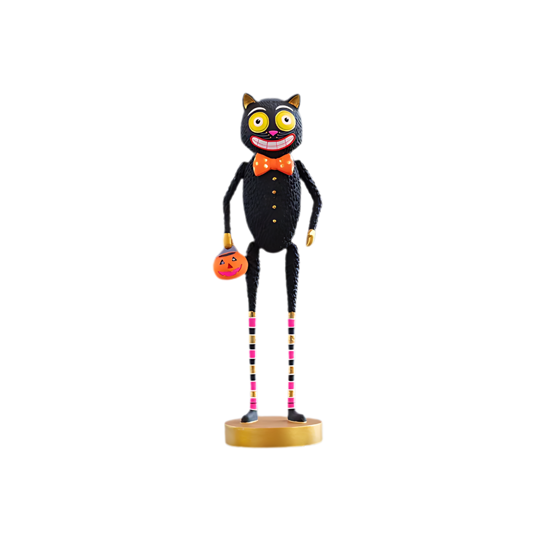 Twitchy. Halloween-themed black cat table top figurine with a pumpkin, colorful legs, and a bow tie on a white background. Glitterville at Mood by DMJ in Lafayette, LA.