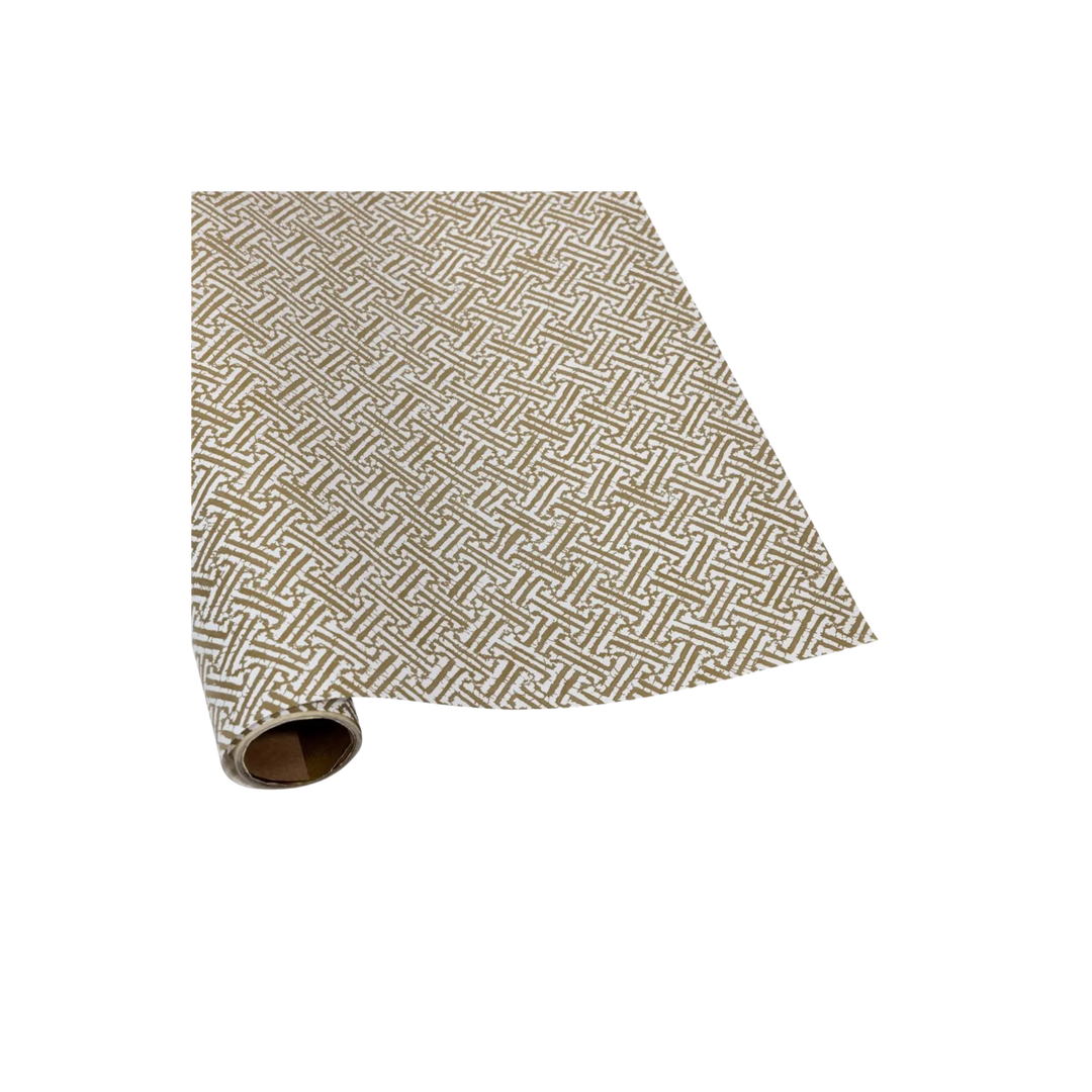 Gold and white wrapping paper roll with a metallic fretwork geometric pattern