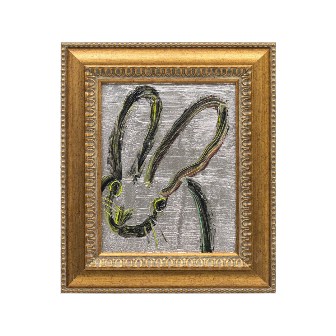 Original Hunt Slonem painting “Green Eyes,” expressive bunny in black strokes with green and yellow accents on a metallic silver background, framed in antique gold.