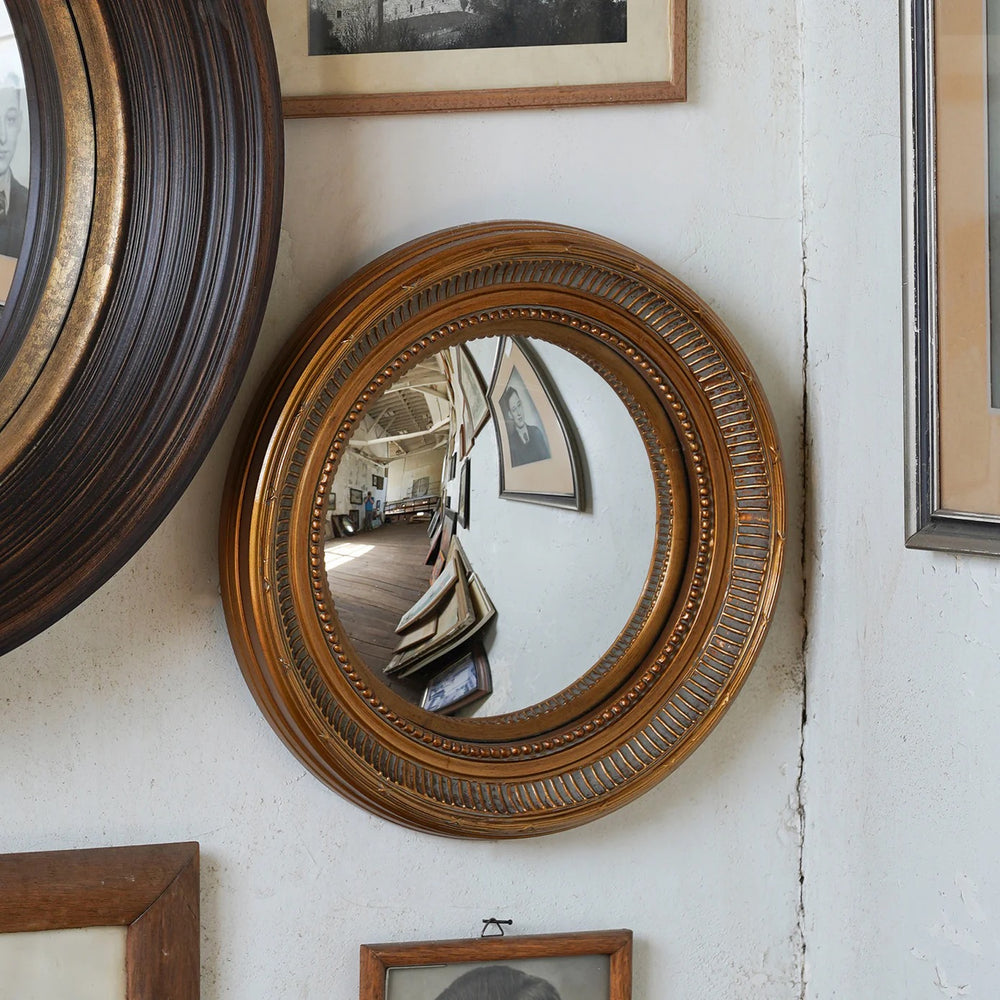 St. Cyr convex mirror with antique washed gold frame, approx 15 inch diameter decorative wall mirror styled on gallery wall from Mood by DMJ