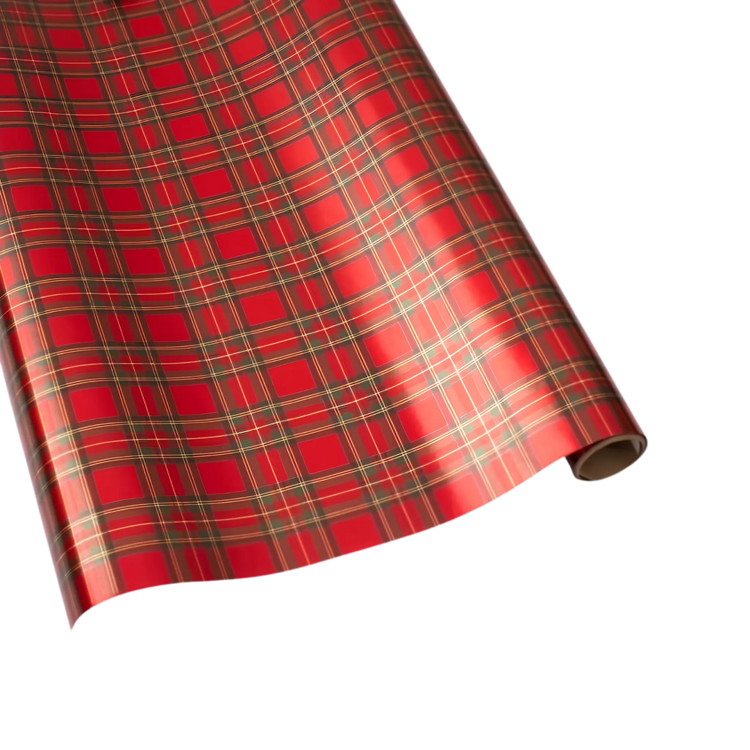 Red tartan plaid wrapping paper roll with gold and green foil stripes