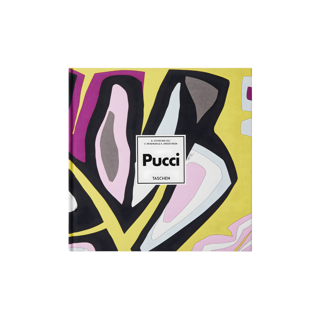 Taschen XL hardcover book Pucci featuring bold abstract prints in yellow, pink, black, and white, bound in original Emilio Pucci fabric, styled on a black background.
