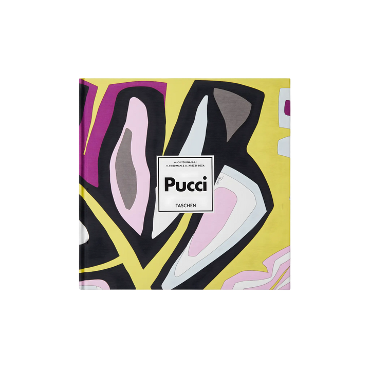 Taschen XL hardcover book Pucci featuring bold abstract prints in yellow, pink, black, and white, bound in original Emilio Pucci fabric, styled on a black background.