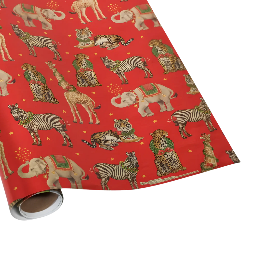 Christmas wrapping paper roll with zebras, tigers, giraffes, elephants, and leopards in festive holiday attire on a red background with gold foil stars
