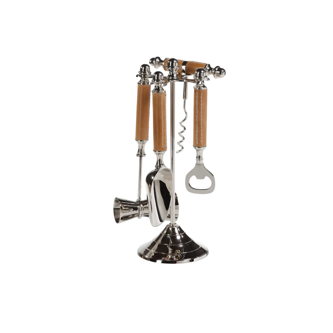 Polished nickel bar tool set with brown leather handles on a metal stand, featuring a corkscrew, jigger, ice scoop, and bottle opener for a stylish home bar.