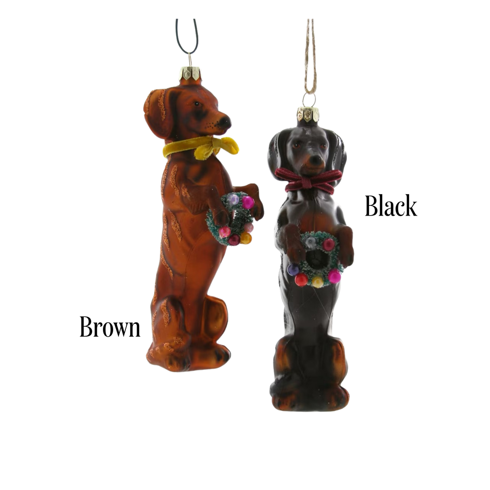 Cody Foster festive doxy dachshund ornament color options, brown and black glass dachshunds in scarves holding wreaths, labeled