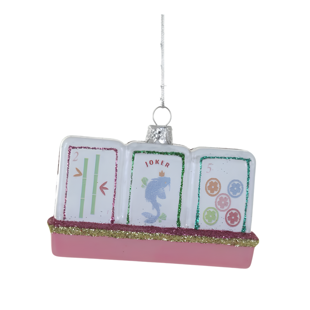 Cody Foster glass mahjong tiles Christmas ornament with bamboo, joker, and flower tiles on a pink glittered rack