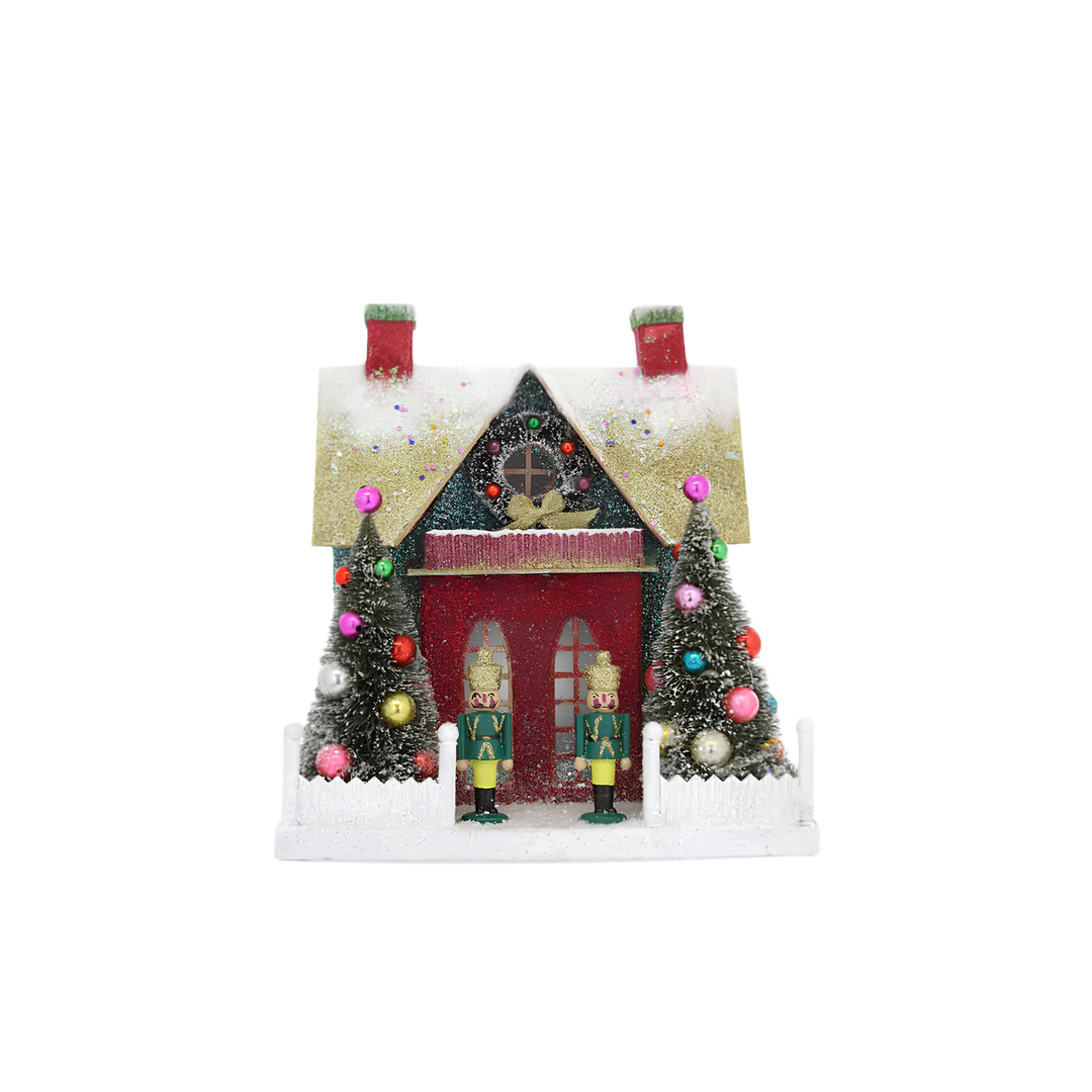 Cody Foster Merry and Bright Cottage Christmas village house, glittered red cottage with nutcracker soldiers, bottle brush trees, and picket fence