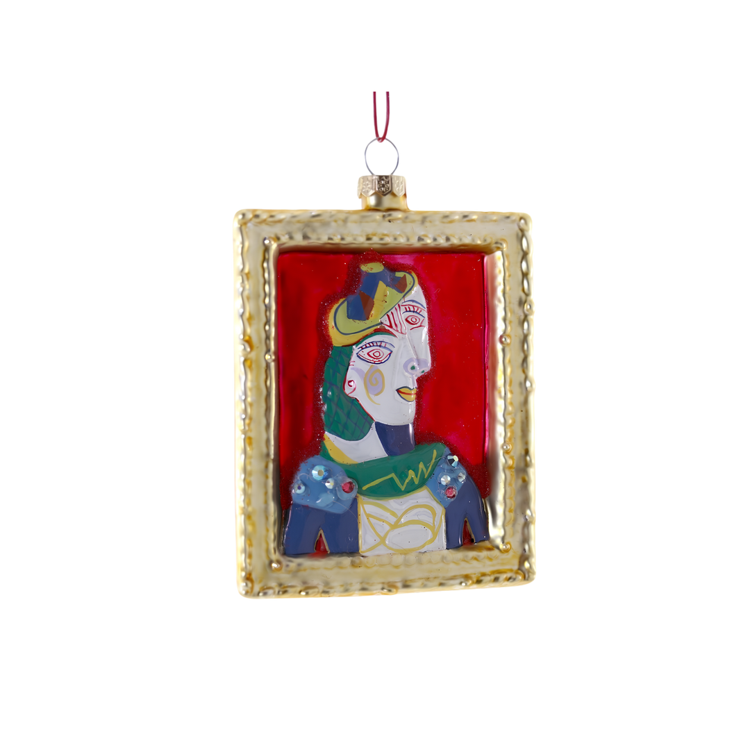 Cody Foster Picasso painting glass Christmas ornament, cubist portrait of a woman in a yellow hat on red inside a gold frame
