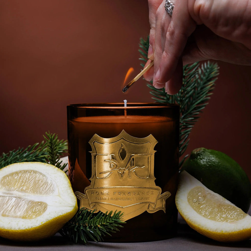 Lighting the Grove luxury citrus candle by DMJ Home Fragrance with a match, hand-poured coconut wax candle with kalamansi lime, green tea