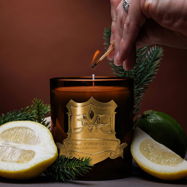 Lighting the Grove luxury citrus candle by DMJ Home Fragrance with a match, hand-poured coconut wax candle with kalamansi lime, green tea