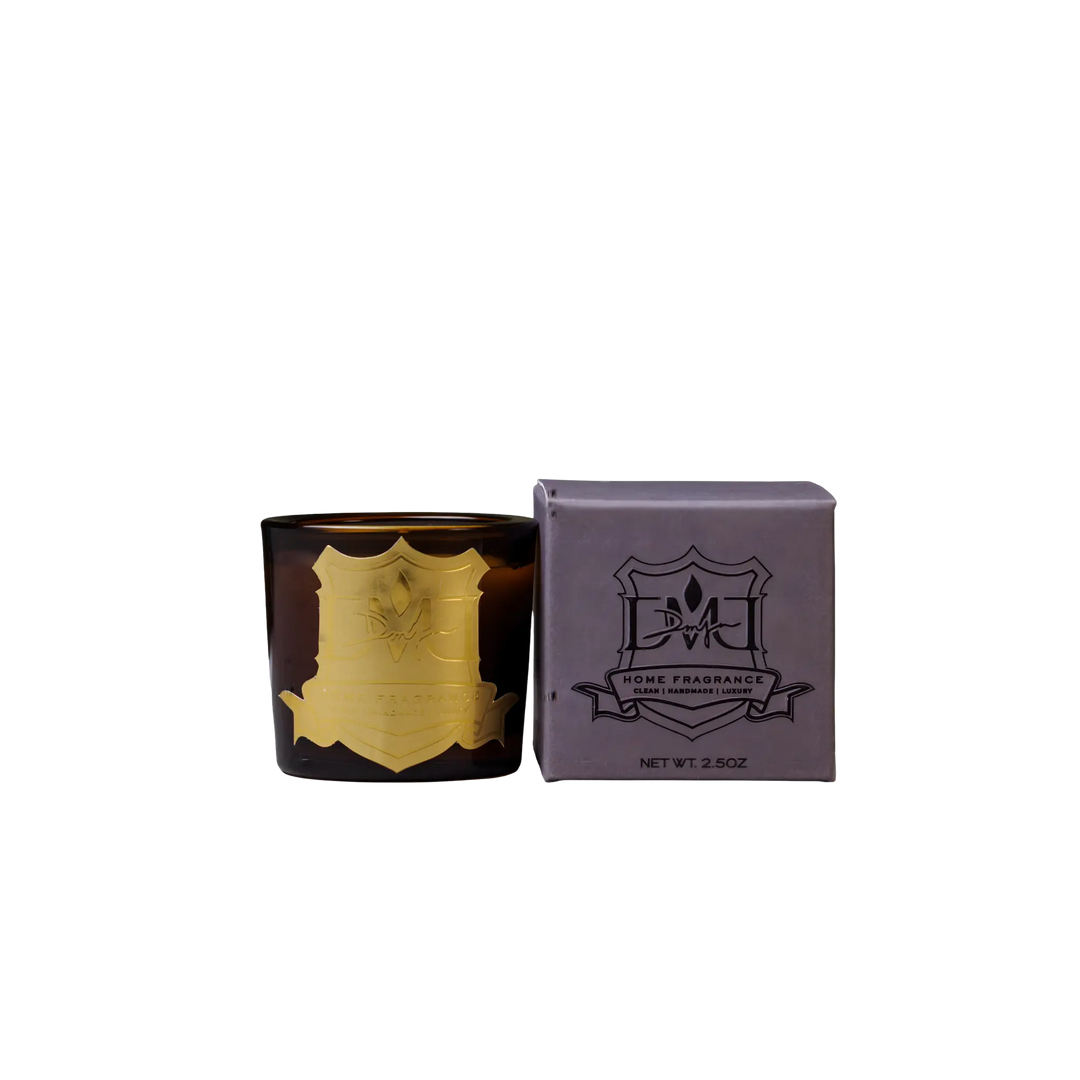 Winter Woods Votive by DMJ Home Fragrance, decorative candle with gold emblem and matching box on a white background