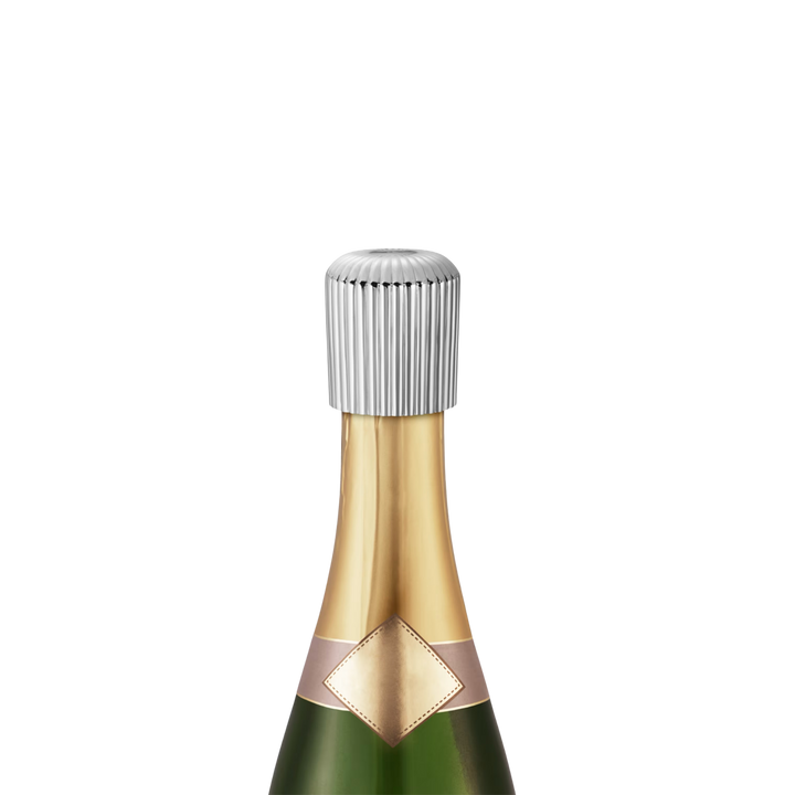 Georg Jensen Bernadotte stainless steel champagne stopper sealing an open bottle of champagne