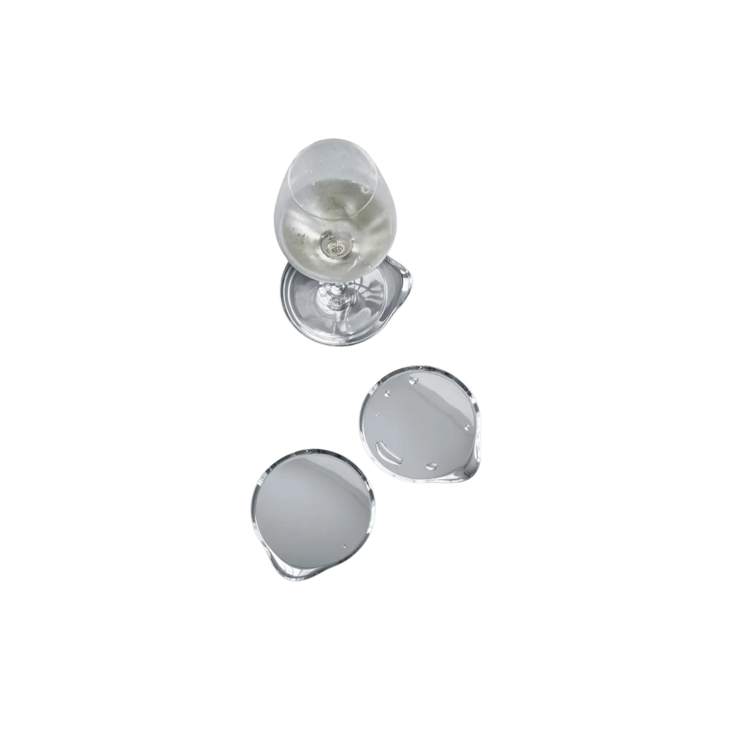 Georg Jensen stainless steel wine coasters set of four in mirror-polished finish with a wine glass