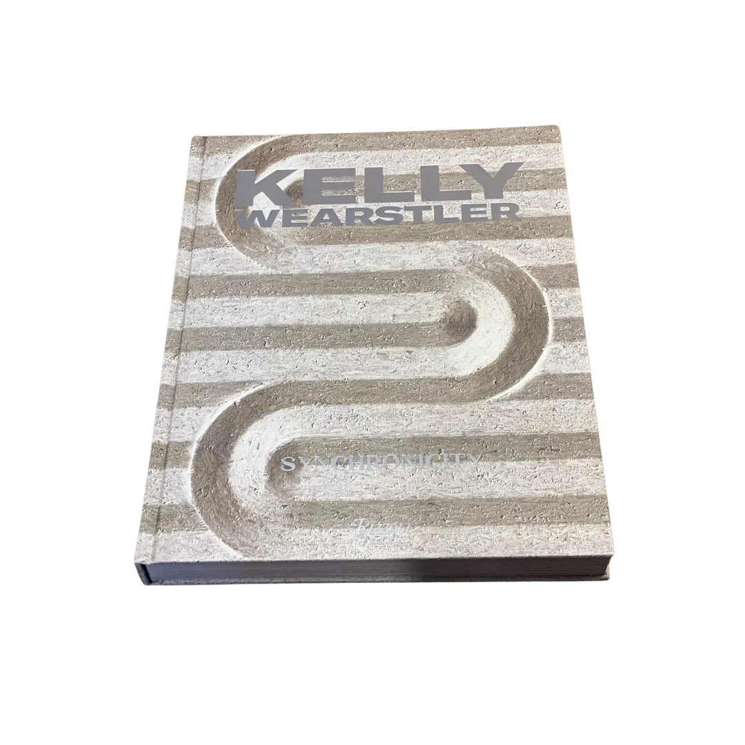 Front cover of Kelly Wearstler: Synchronicity, a Rizzoli interior design book with a striped stone relief design
