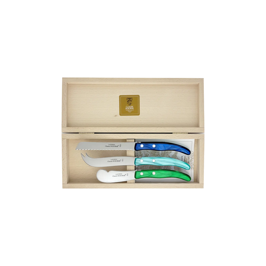 Laguiole Cheese Set by Claude Dozorme with blue and green Berlingot handles — handcrafted 3-piece French cheese knife, slicer, and spreader in a wooden gift box. Made in Thiers, France — luxury cheese board accessories for entertaining and gifting.