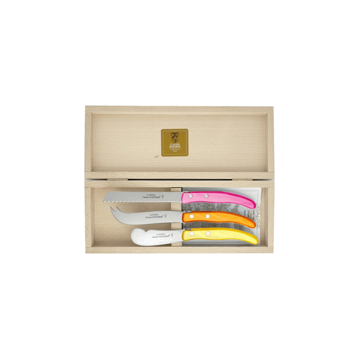 Laguiole Cheese Set by Claude Dozorme with pink, orange, and yellow Berlingot handles — handcrafted 3-piece French cheese knife, slicer, and spreader in a wooden gift box. Made in Thiers, France — luxury cheese board accessories for entertaining and gifting.