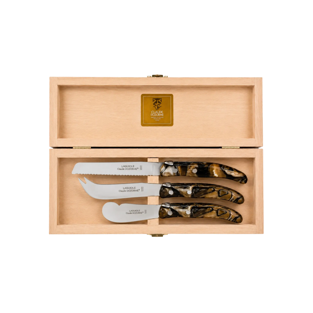 Laguiole Cheese Set by Claude Dozorme with smokey quartz handles — handcrafted 3-piece French cheese knife, slicer, and spreader in a wooden gift box. Made in Thiers, France — luxury cheese board accessories for entertaining and gifting.