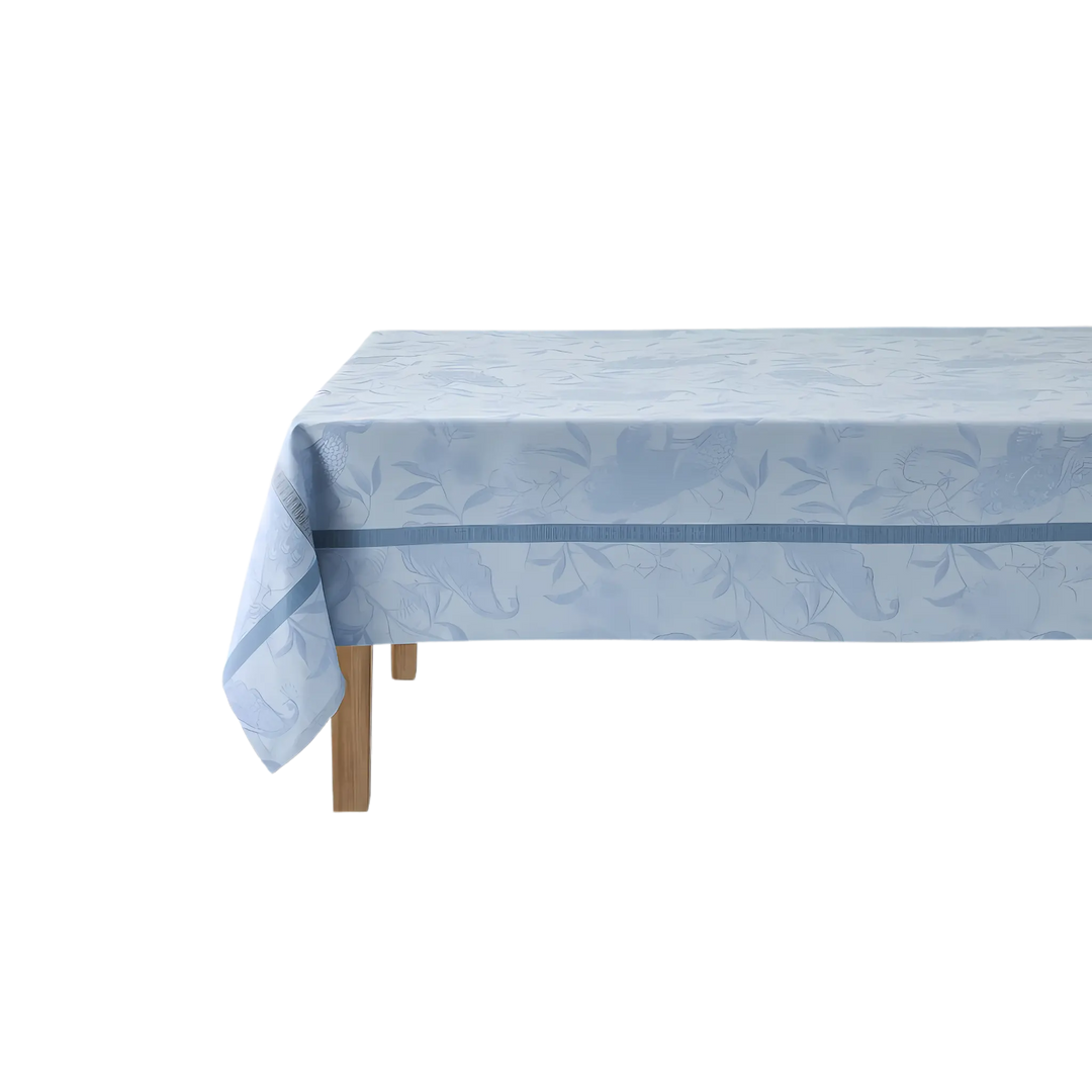 Le Jacquard Français A L'Orangerie linen tablecloth in light blue from Mood by DMJ, 69 inch square French linen tablecloth with peacocks
