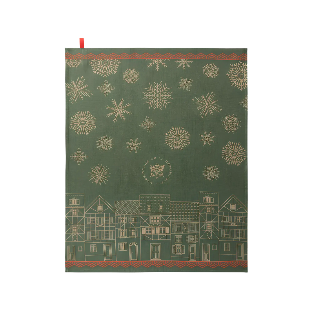 Le Jacquard Français Christmas Village tea towel from Mood by DMJ, forest green cotton kitchen towel with gold snowflakes and a French village