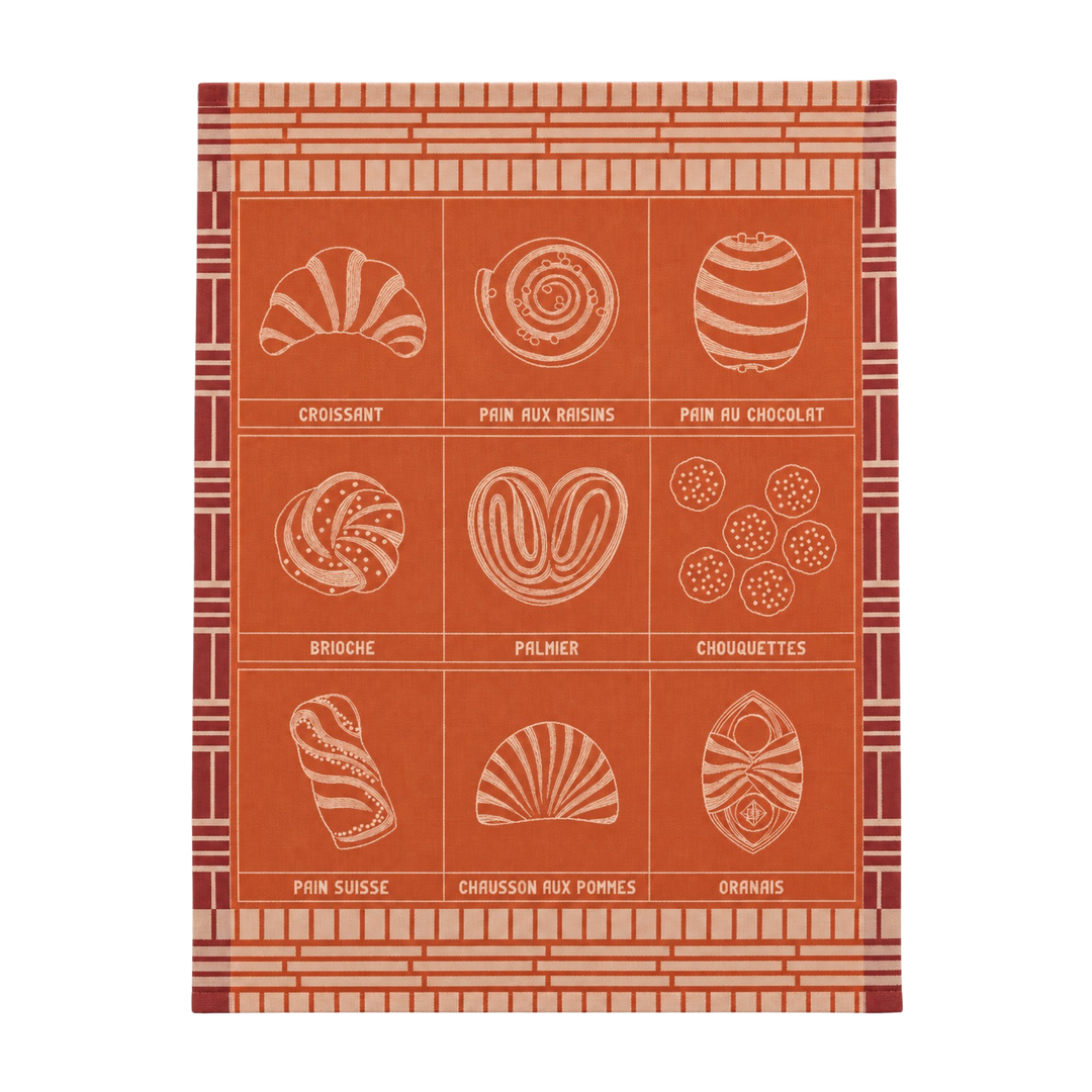 Le Jacquard Français fine pastry tea towel in orange from Mood by DMJ, woven cotton kitchen towel with croissant, brioche, and French pastries
