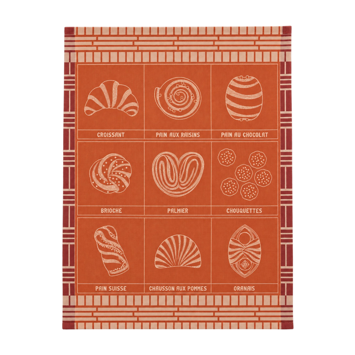 Le Jacquard Français fine pastry tea towel in orange from Mood by DMJ, woven cotton kitchen towel with croissant, brioche, and French pastries