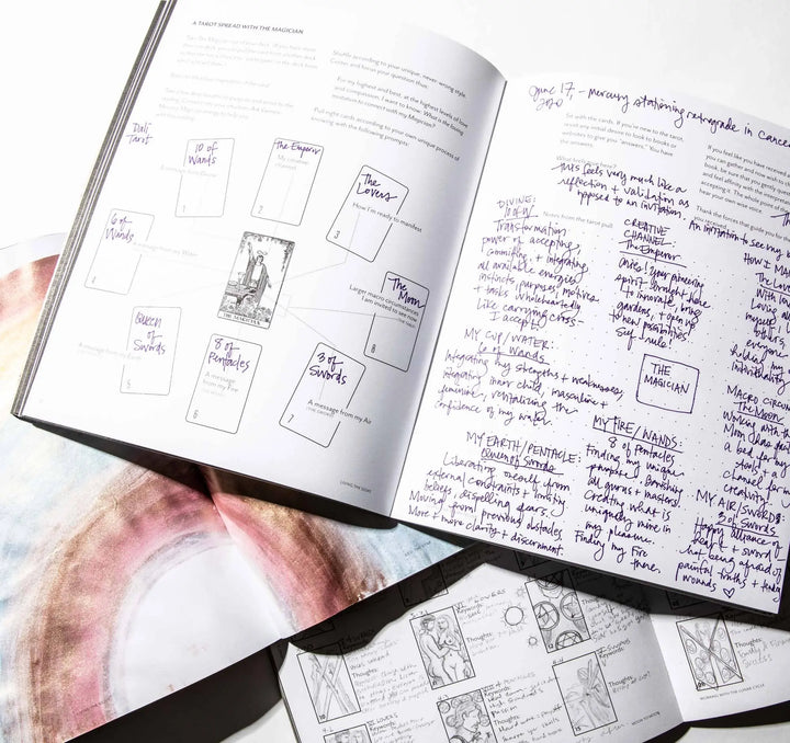 Open pages of a Living the Signs workbook by Britten LaRue with a tarot spread and handwritten journaling notes
