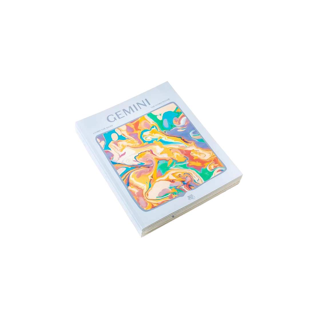 Living the Signs: Gemini astrology workbook by Britten LaRue, angled paperback with pastel marbled cover on black
