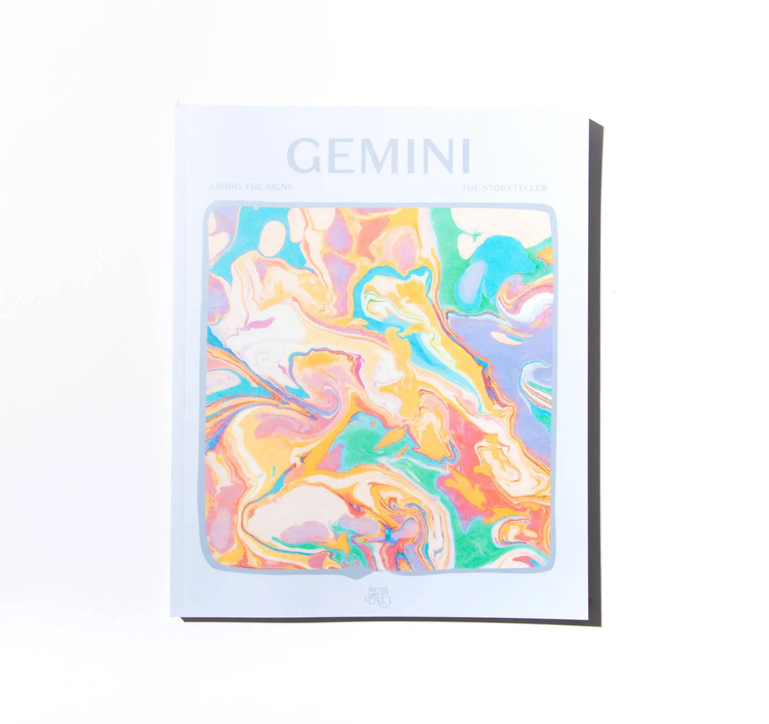 Front cover of Living the Signs: Gemini, The Storyteller, a pale paperback with pastel marbled art by In Case of Emergence