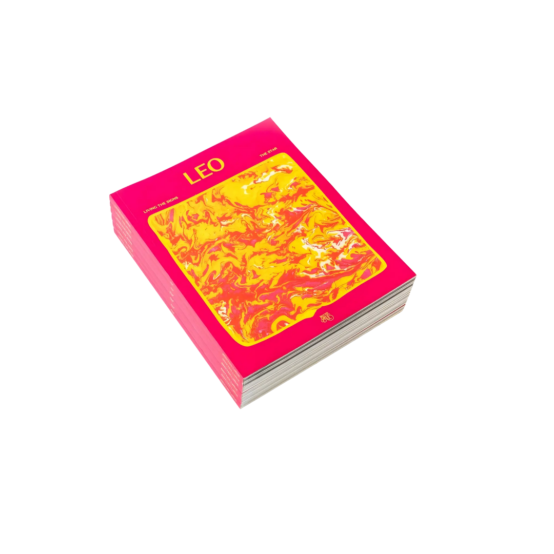 Living the Signs: Leo astrology workbook by Britten LaRue, angled paperback with hot pink marbled cover on black