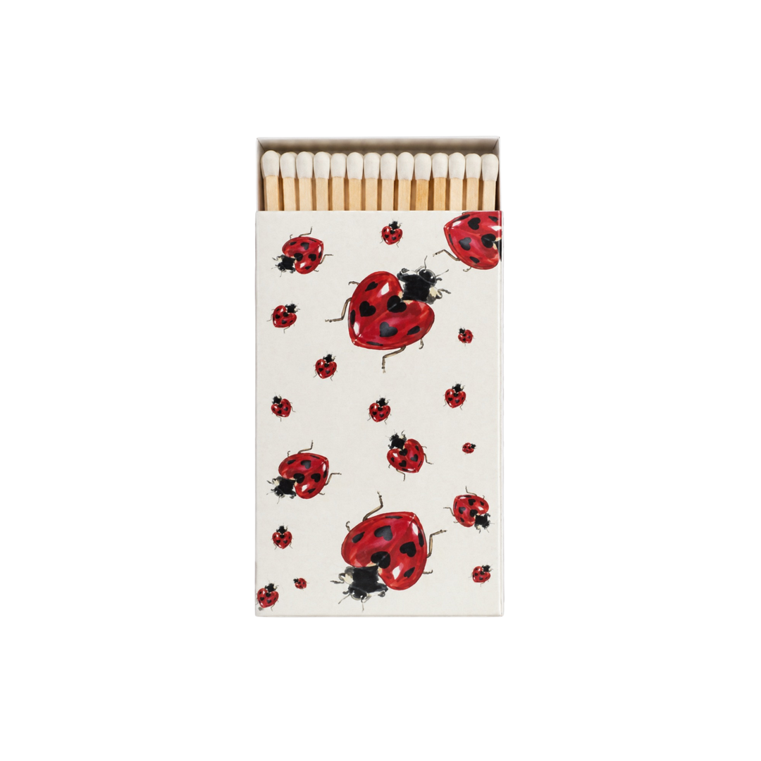 Saint Austin Lady Bug Match Box with a red ladybug print on a cream cover and white-tipped wooden matches inside