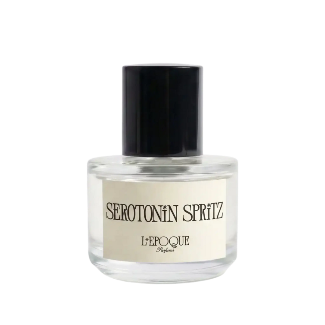 A clear glass bottle of L'Époque Serotonin Spritz perfume with a black cap and a cream-colored label, centered on a plain white background